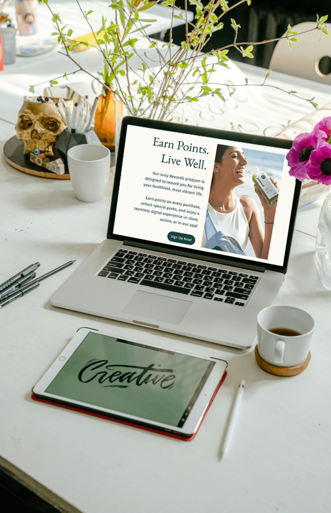 A laptop displaying the juicy rewards landing page.
